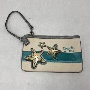 Coach brand beach vibes wristlet. Color: white and teal.